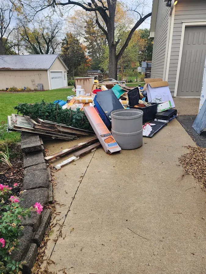 Dumpster being loaded with debris for Estate Cleanout Dumpster Rental in Ralston